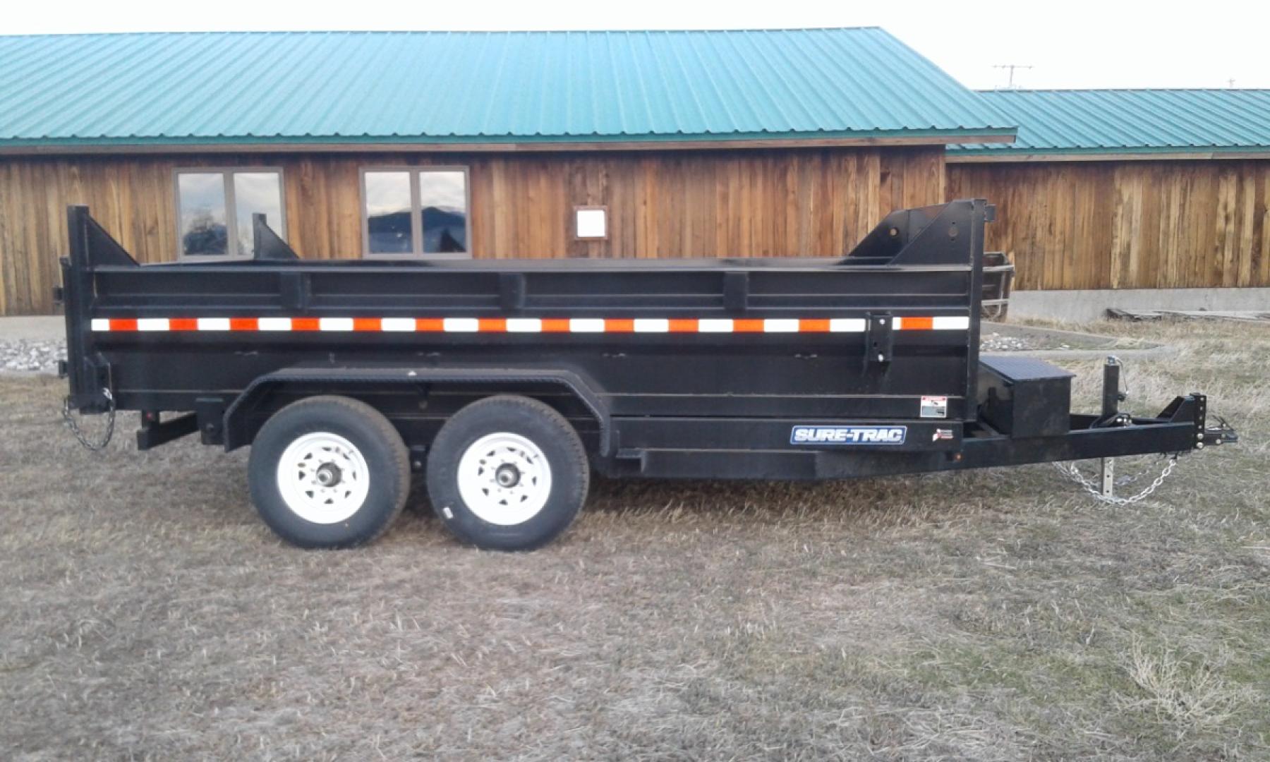 2024 Black SureTrac 7 x 14 LoPro Dump , located at 310 West 1st Ave, Big Timber, MT, 59011, (406) 860-8510, 45.833511, -109.957809 - SURE-TRAC 7 x 14 LO PRO DUMP TRAILER, 14K GVW, TELESCOPIC HOIST, UNDERBODY TOOL STORAGE BOX, STAKE POCKETS ON SIDE, MESH TARP, 110 VOLT BATTERY CHARGER, SIDE STEP, EZ LUBE HUBS, HD SLIPPER SPRING SUSPENSION, 16" RADIAL 10 PLY TIRES, BRAKES BOTH AXLES, SPREADER-BARN DOOR REAR GATE, REAR RAMPS, 10 GA - Photo#0