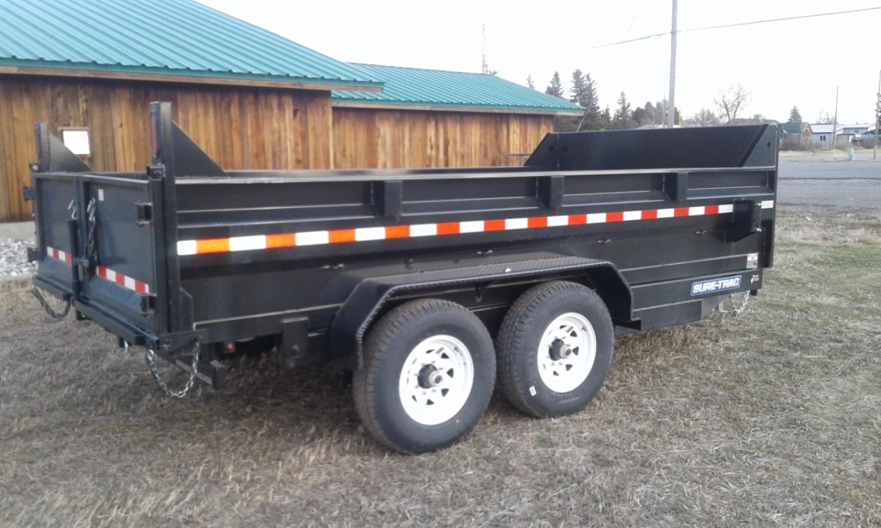 2024 Black SureTrac 7 x 14 LoPro Dump , located at 310 West 1st Ave, Big Timber, MT, 59011, (406) 860-8510, 45.833511, -109.957809 - SURE-TRAC 7 x 14 LO PRO DUMP TRAILER, 14K GVW, TELESCOPIC HOIST, UNDERBODY TOOL STORAGE BOX, STAKE POCKETS ON SIDE, MESH TARP, 110 VOLT BATTERY CHARGER, SIDE STEP, EZ LUBE HUBS, HD SLIPPER SPRING SUSPENSION, 16" RADIAL 10 PLY TIRES, BRAKES BOTH AXLES, SPREADER-BARN DOOR REAR GATE, REAR RAMPS, 10 GA - Photo#1