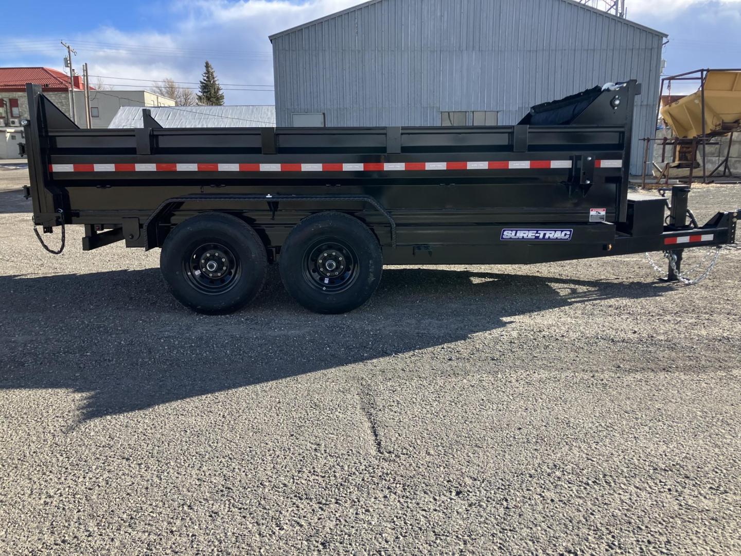 2025 Black SureTrac 7 x 14 LoPro Dump , located at 310 West 1st Ave, Big Timber, MT, 59011, (406) 860-8510, 45.833511, -109.957809 - SURE-TRAC 7 x 14 HD LO PRO DUMP TRAILER, 14K GVW, TELESCOPIC HOIST, UNDERBODY TOOL STORAGE BOX, STAKE POCKETS ON SIDE, MESH TARP, 110 VOLT BATTERY CHARGER, SIDE STEP, EZ LUBE HUBS, HD SLIPPER SPRING SUSPENSION, 16" RADIAL 10 PLY TIRES, BRAKES BOTH AXLES, SPREADER-BARN DOOR REAR GATE, REAR RAMPS, 10 - Photo#1