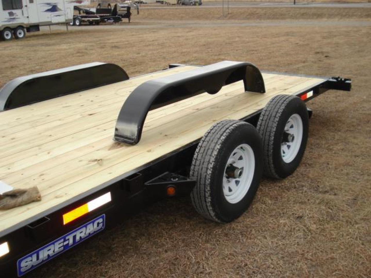 2025 Black 7 x 20-10K Car Hauler , located at 310 West 1st Ave, Big Timber, MT, 59011, (406) 860-8510, 45.833511, -109.957809 - SURE-TRAC 7 x 20 C-CHANNEL CAR HAULER, 10K GVW, 2' DOVETAIL, REAR STOW RAMPS, 15" - 8 PLY RADIAL TIRES, EZ LUBE HUBS, BRAKES BOTH AXLES, SIDE POCKETS, 2 X 6 TREATED WOOD DECK, (4) D-RINGS, LED LIGHTS, 7K SET-BACK DROP LEG JACK, SPARE MOUNT, 5" C-CHANNEL FRAME, 5" C-CHANNEL FULL WRAP TONGUE, 2-5-16" - Photo#4