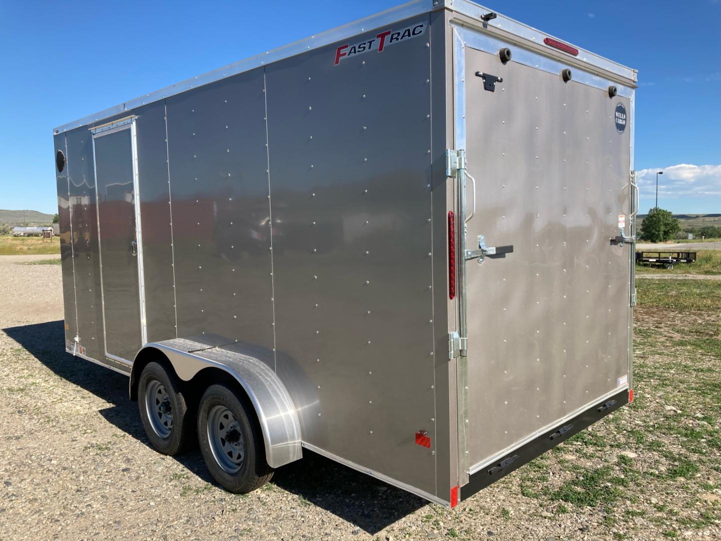 2024 White Wells Cargo Fast Trac 7 x 14 , located at 310 West 1st Ave, Big Timber, MT, 59011, (406) 860-8510, 45.833511, -109.957809 - Wells Cargo Fast Trac 7 x 14 V-nose, 7k GVW, rear ramp door with 78" rear door opening height (fits a side by side), spring suspension, electric brakes all wheels, 15" radial tires, ez lube hubs, (4) d-ring tie-downs, Plexcore 3/4" floor, economy sidewall liner, flow through sidewall vents, one piec - Photo#1