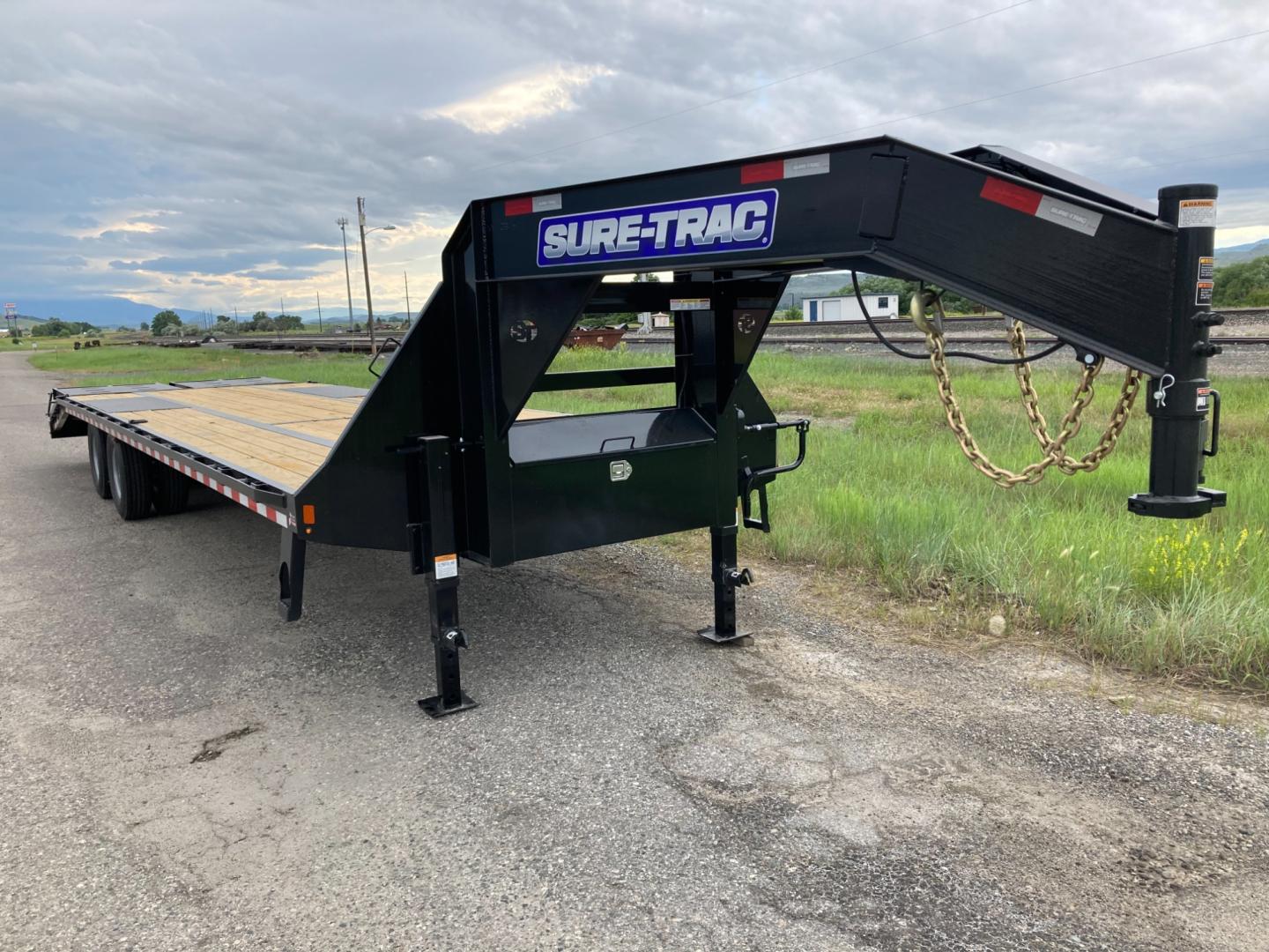 2025 SureTrac , located at 310 West 1st Ave, Big Timber, MT, 59011, (406) 860-8510, 45.833511, -109.957809 - SureTrac 81/2 x 27+5 GN Deckover, 25.9 GVW, 14ply - 16" radial tires, 12k Dexter axles with oil bath hubs, HD slipper spring suspension, electric brakes all wheels, LED lights, 5' self cleaning beavertail with (2) 4' wide spring assist flip over ramps with hold-down straps, 2x6 treated wood deck, du - Photo#2